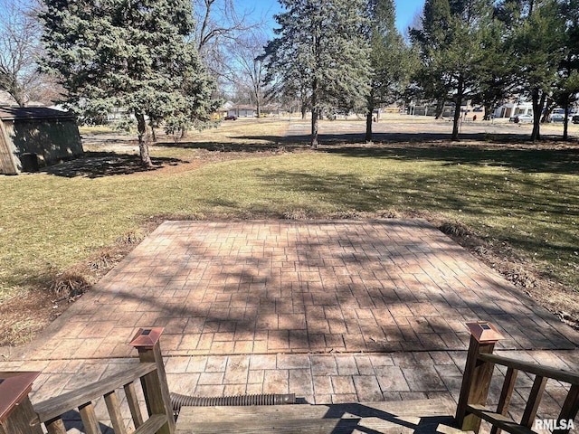 wooden terrace with a patio and a lawn