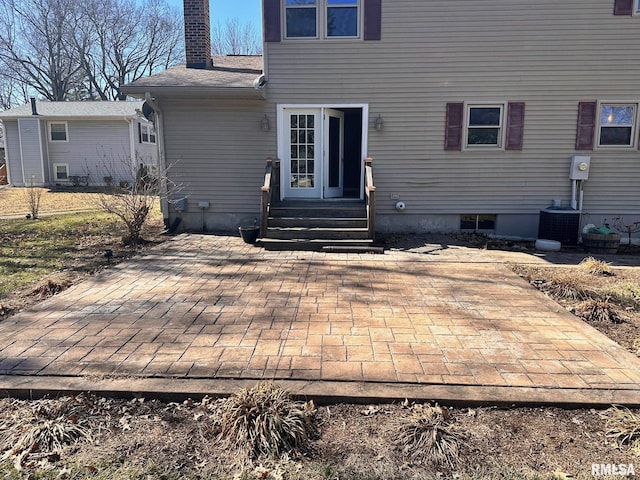 rear view of property featuring cooling unit, a patio, a chimney, and entry steps