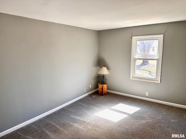 carpeted empty room with baseboards