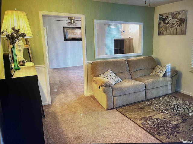 living room featuring carpet floors and a ceiling fan