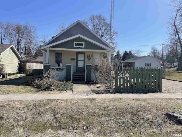 bungalow-style home featuring fence and covered porch