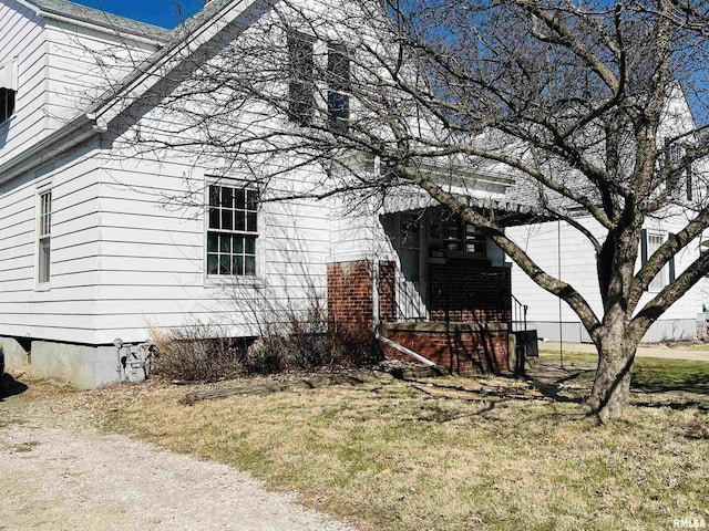 view of home's exterior with a lawn