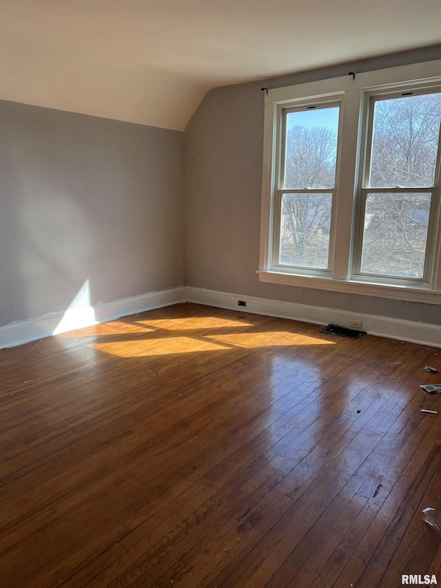 bonus room with visible vents, baseboards, lofted ceiling, and hardwood / wood-style floors