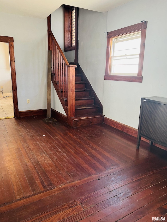 interior space featuring baseboards and wood-type flooring