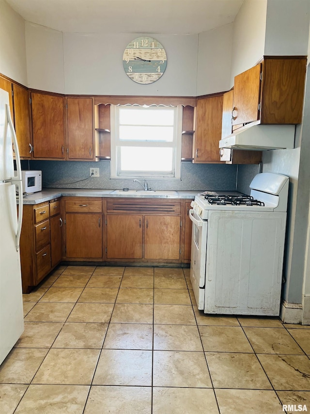 kitchen featuring open shelves, white appliances, brown cabinets, and a sink