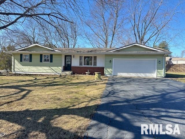 ranch-style home featuring a garage, brick siding, and driveway