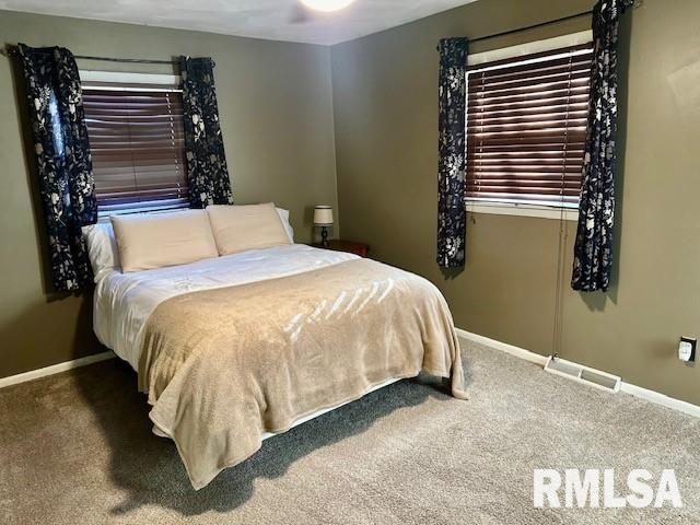 bedroom featuring visible vents, baseboards, and carpet floors