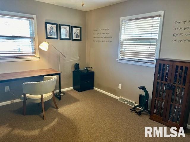 carpeted office featuring visible vents and baseboards