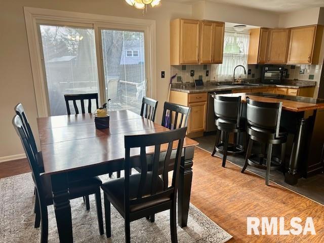 dining room featuring light wood-type flooring and baseboards