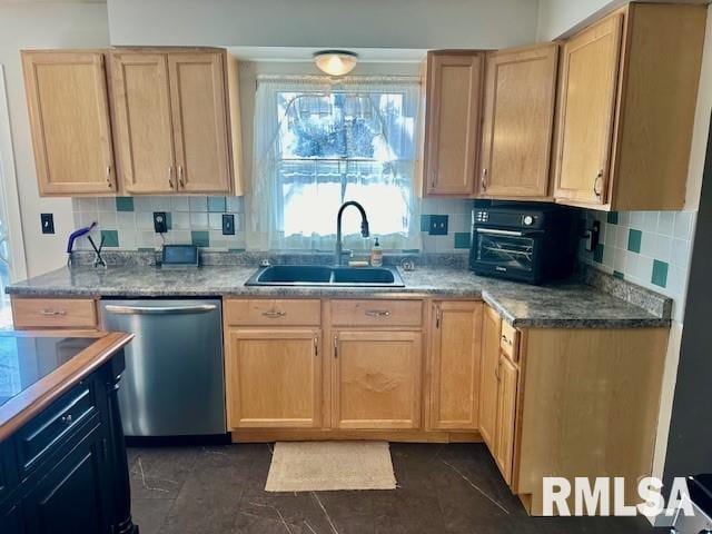 kitchen featuring stainless steel dishwasher, light brown cabinets, backsplash, and a sink