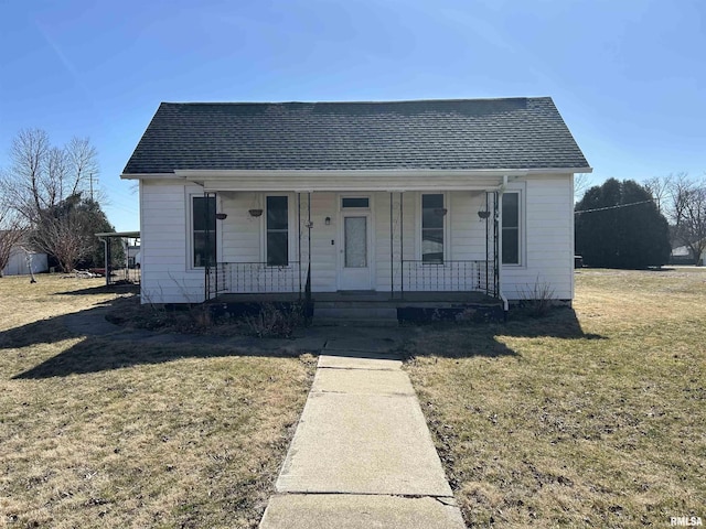 bungalow featuring roof with shingles, a porch, and a front yard