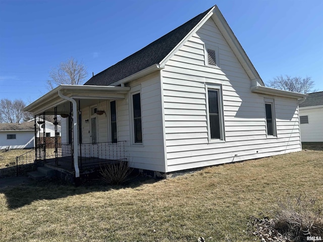 view of home's exterior featuring a yard and covered porch