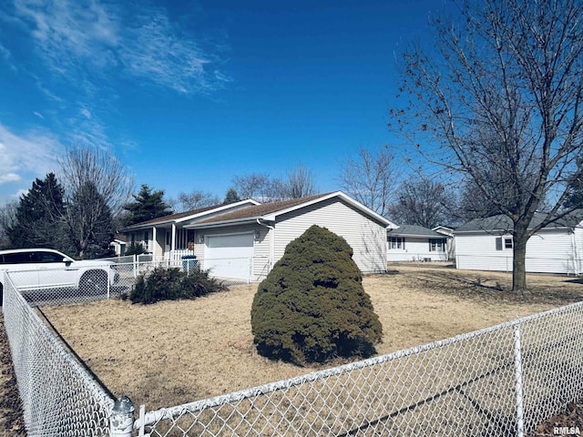 view of side of home featuring an attached garage and fence private yard