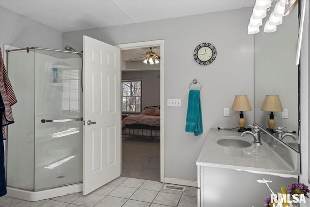 ensuite bathroom featuring visible vents, a shower stall, ensuite bath, tile patterned floors, and vanity