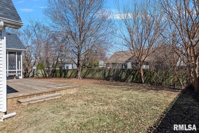 view of yard with a sunroom, a deck, and fence