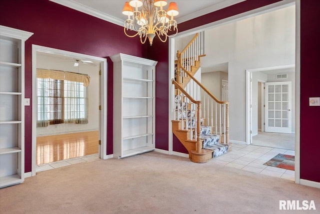 carpeted spare room with visible vents, crown molding, and stairway