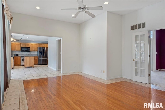 unfurnished living room featuring visible vents, baseboards, light tile patterned floors, recessed lighting, and a ceiling fan