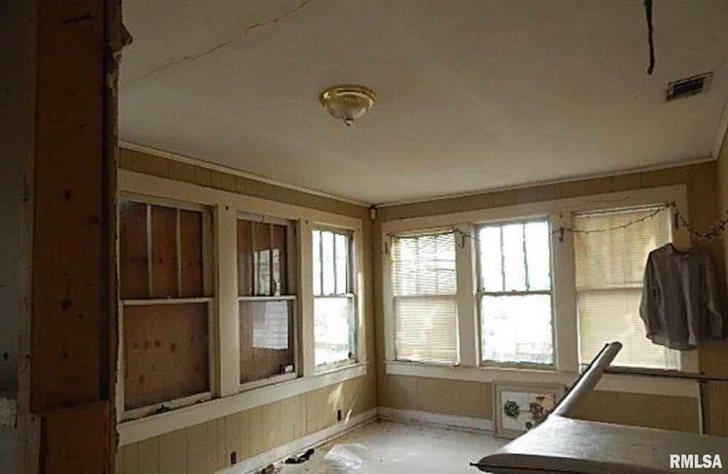 unfurnished sunroom featuring visible vents