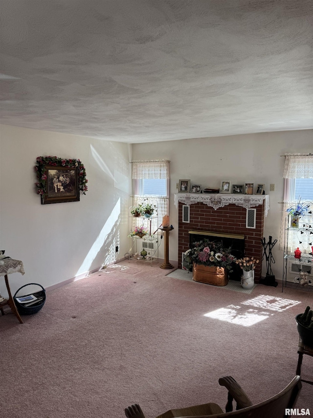 carpeted living area with a brick fireplace and a textured ceiling