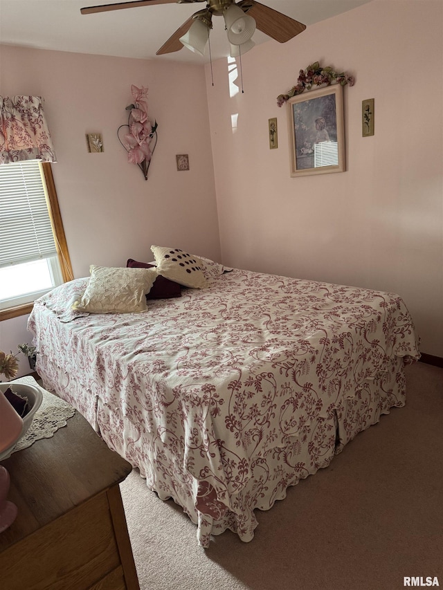 bedroom with a ceiling fan and carpet flooring