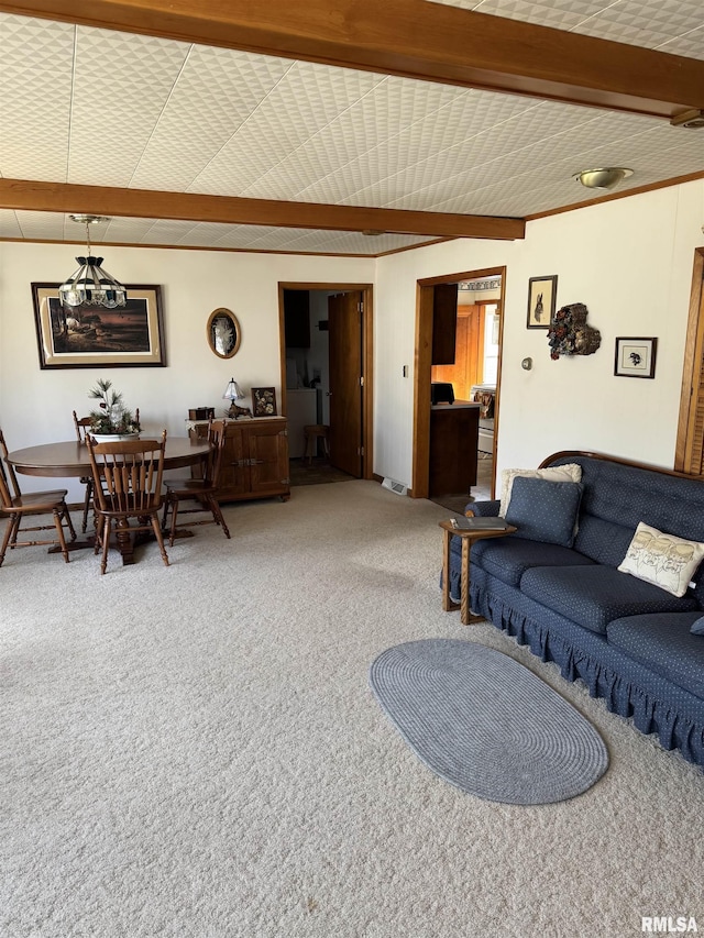 carpeted living room featuring beamed ceiling