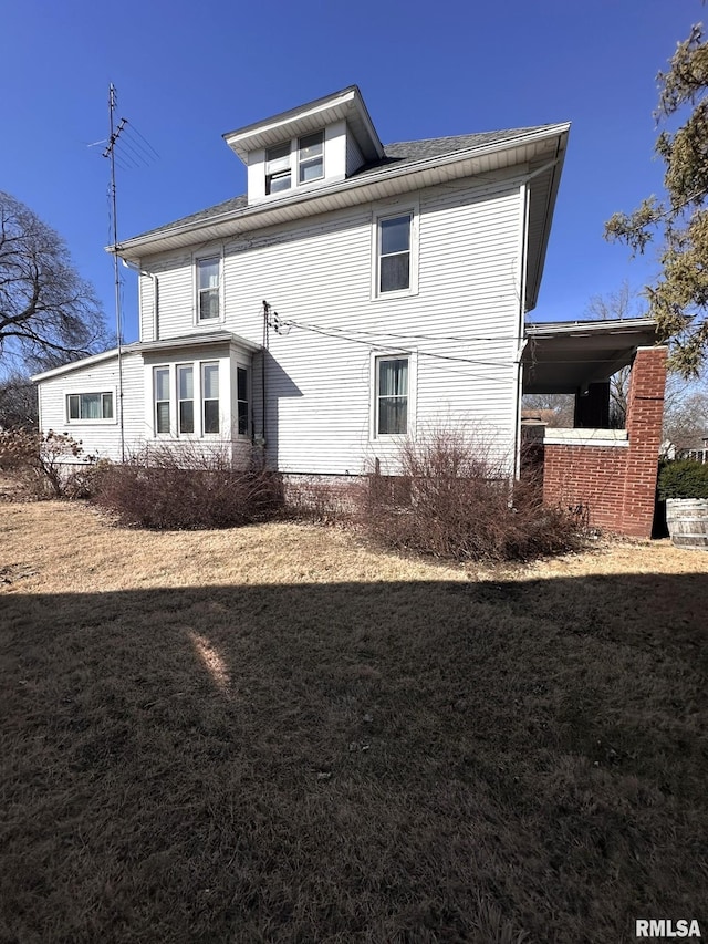 rear view of property with a lawn