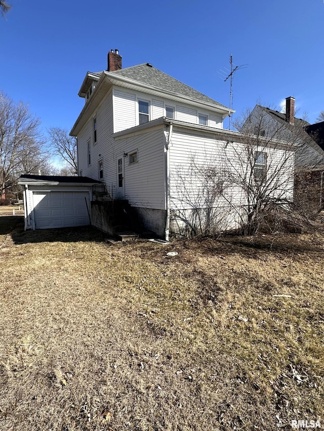 back of house with a chimney