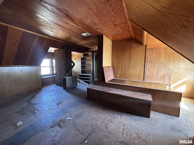 additional living space with wooden walls, wooden ceiling, and lofted ceiling