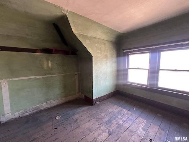 bonus room with lofted ceiling, baseboards, and wood-type flooring