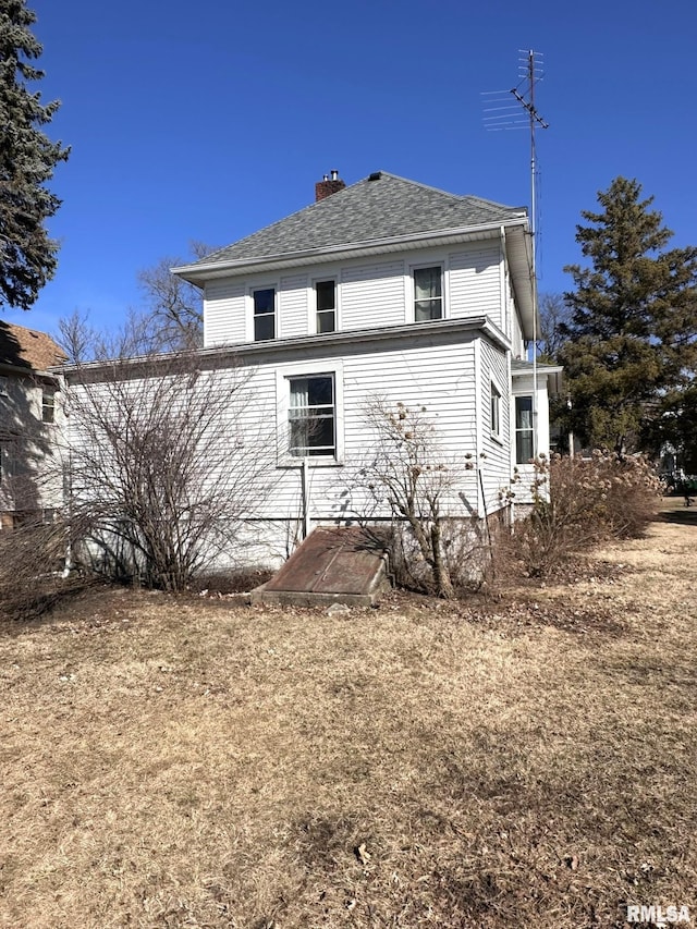 view of property exterior with a chimney