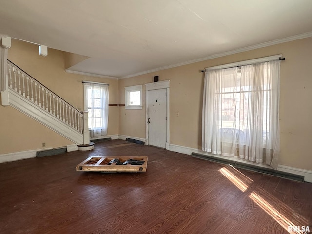 entryway featuring wood finished floors, baseboards, visible vents, stairs, and crown molding