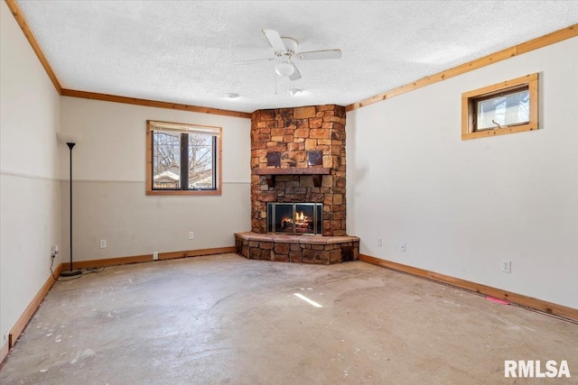 unfurnished living room with baseboards, unfinished concrete floors, a textured ceiling, and a fireplace