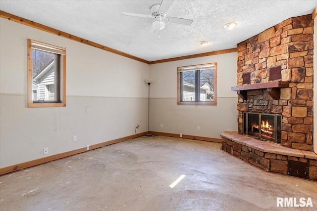 unfurnished living room featuring a textured ceiling, a fireplace, baseboards, ceiling fan, and unfinished concrete floors