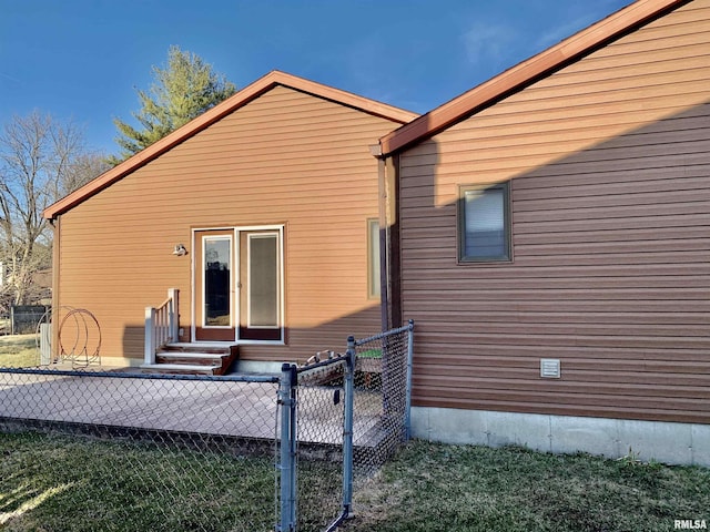 back of property with entry steps and fence