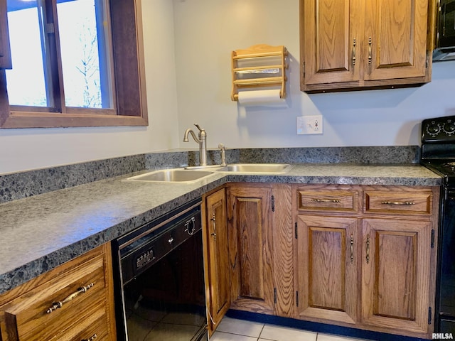 kitchen featuring light tile patterned floors, a sink, black appliances, dark countertops, and brown cabinets