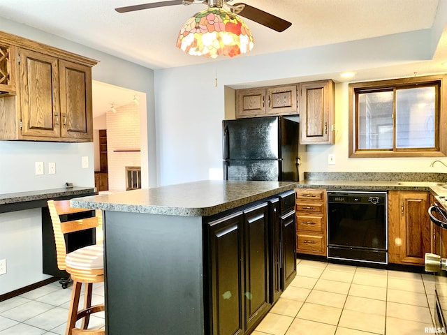 kitchen with light tile patterned flooring, ceiling fan, a sink, black appliances, and a center island