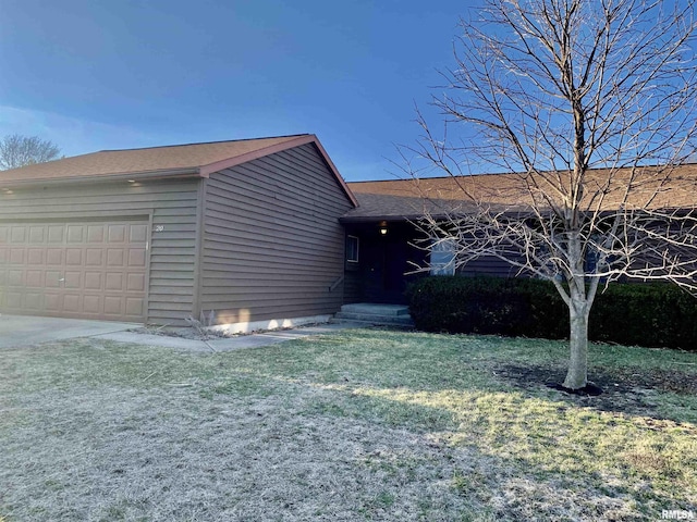 view of front of property with a front yard and a garage