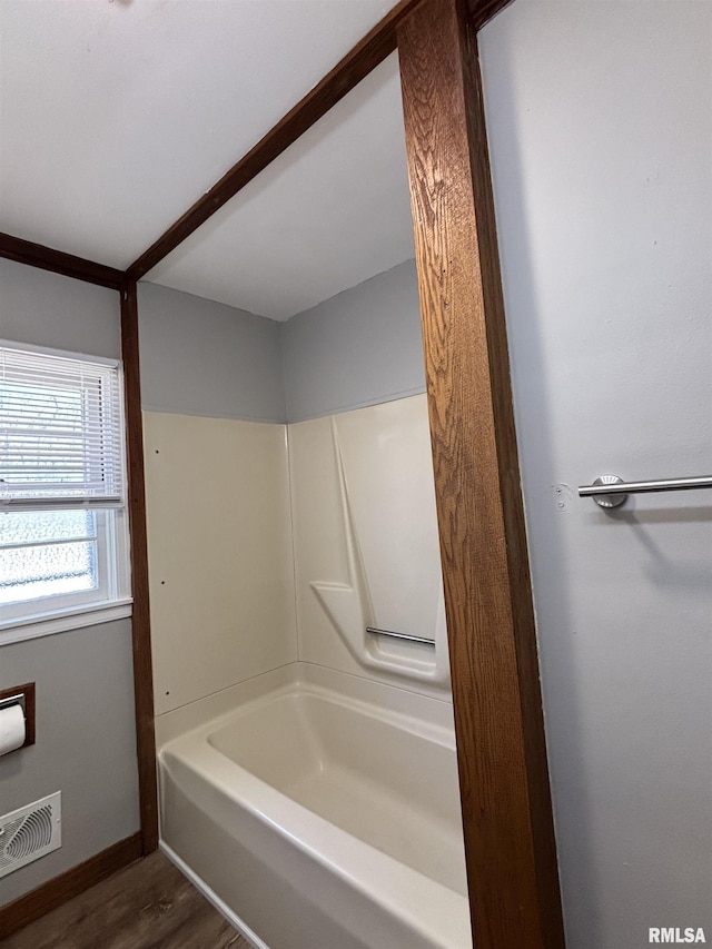 full bath featuring visible vents, baseboards, and wood finished floors