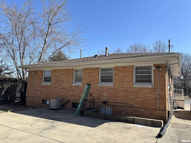 back of property with brick siding and fence