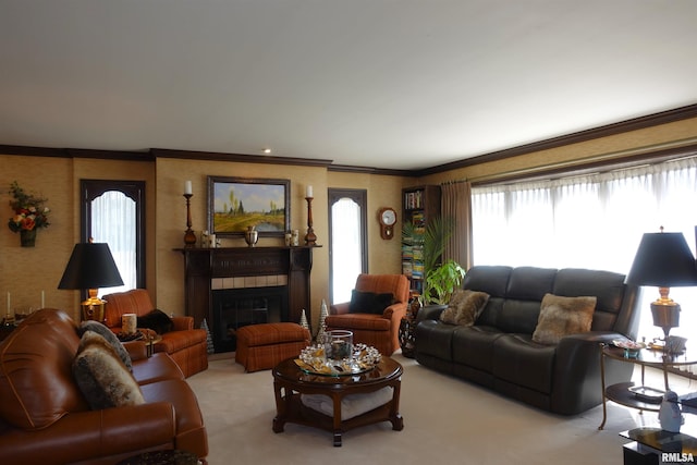 living room featuring a glass covered fireplace, light colored carpet, wallpapered walls, and ornamental molding