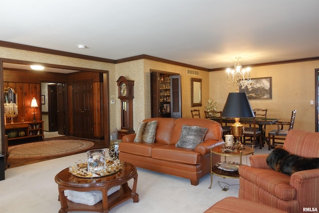 carpeted living area with visible vents, a notable chandelier, ornamental molding, and wallpapered walls