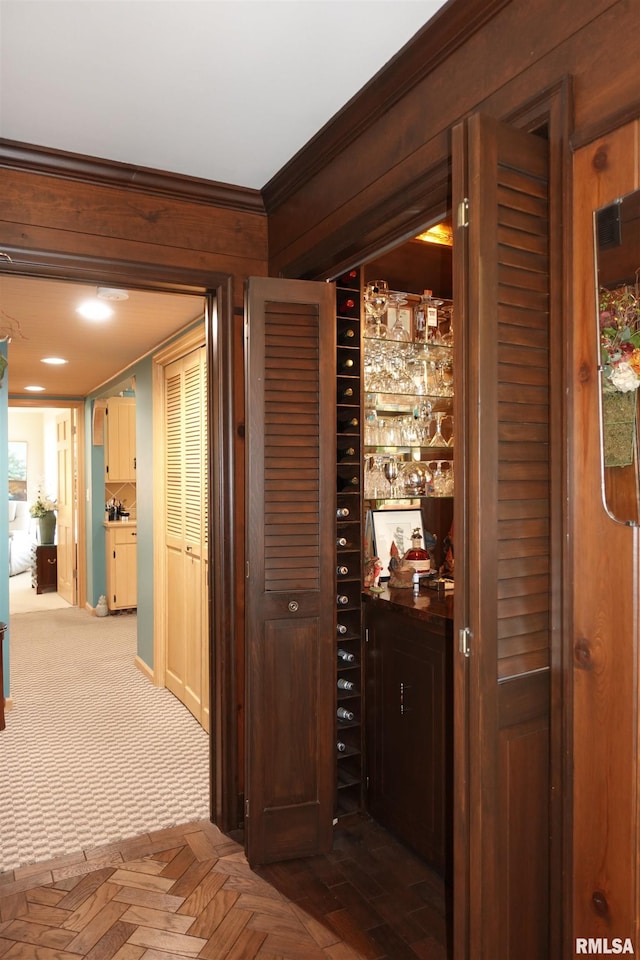 wine area featuring crown molding