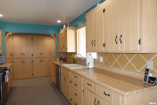 kitchen featuring black stove, a sink, recessed lighting, light countertops, and decorative backsplash