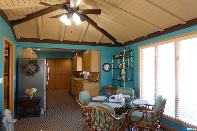 dining area with light carpet, vaulted ceiling with beams, and ceiling fan