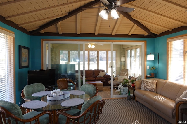 interior space featuring a ceiling fan and vaulted ceiling with beams