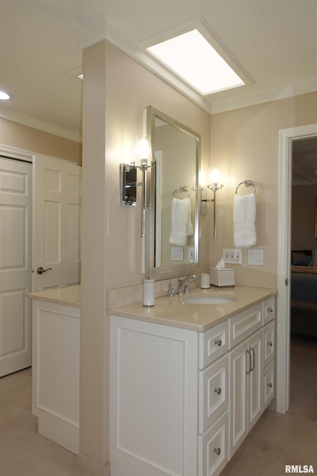 bathroom with ornamental molding and vanity