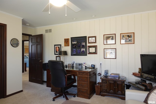 home office featuring visible vents, light colored carpet, ceiling fan, and crown molding