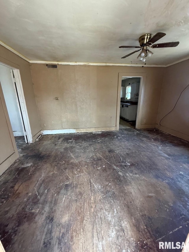 unfurnished room with visible vents, crown molding, and hardwood / wood-style floors