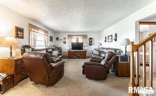 living room featuring light carpet, a textured ceiling, and stairs