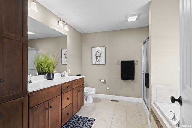 bathroom featuring tile patterned flooring, visible vents, double vanity, a shower with shower door, and a sink